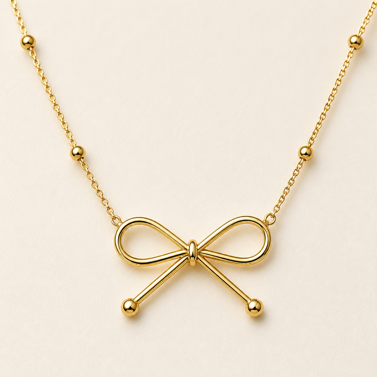 Nœud gold bow necklace — close-up detail